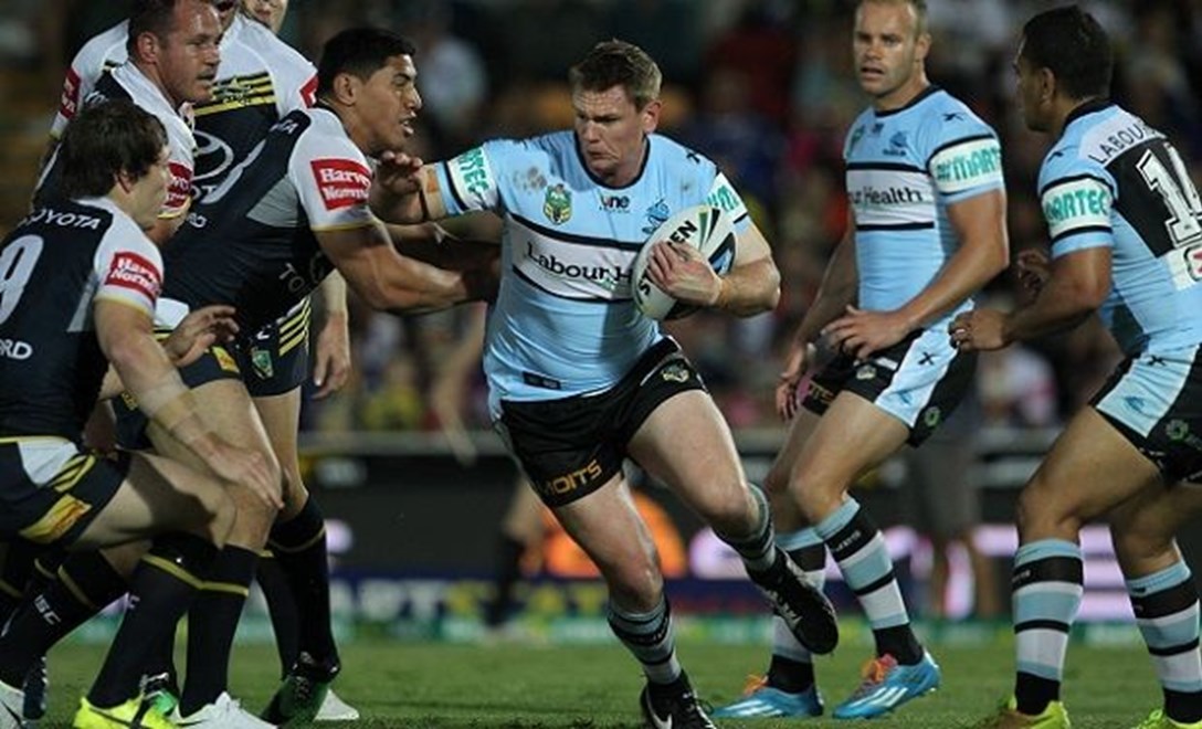 Photo by Colin Whelan copyright © nrlphotos.com :     tim Robinson tries to fend Jason Taumalolo                          NRL Rugby League, Round 25 North Queensland Cowboys v Cronulla Sharks at Townsville, Monday September 1st 2014