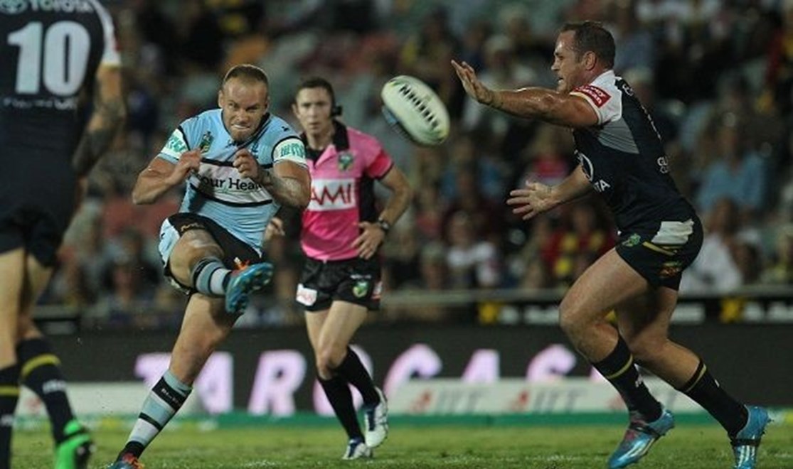 Photo by Colin Whelan copyright © nrlphotos.com :     Daniel Holdsworth beats the challenge of Matt Scott to even the scores late in the match                          NRL Rugby League, Round 25 North Queensland Cowboys v Cronulla Sharks at Townsville, Monday September 1st 2014