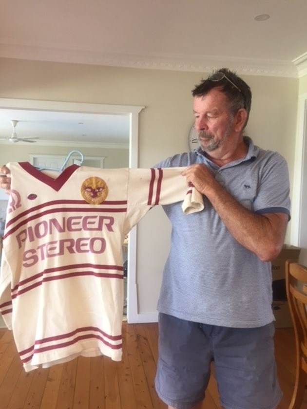Kneen holding a 1978 Manly grand final jersey.