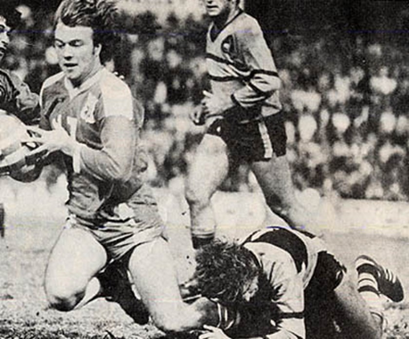 Steve Kneen tackles Wally Lewis in the Amco Cup final.