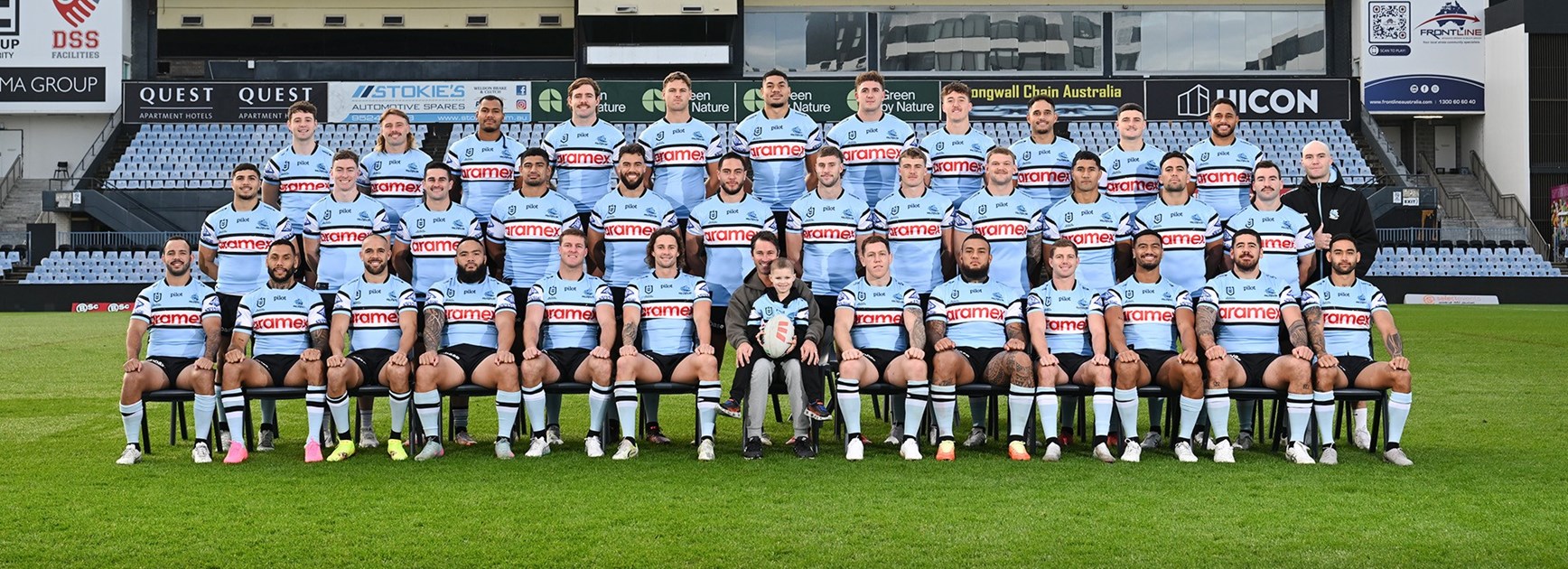 Liam, front and centre, with dad Adam, at the Sharks team photo shoot in 2025