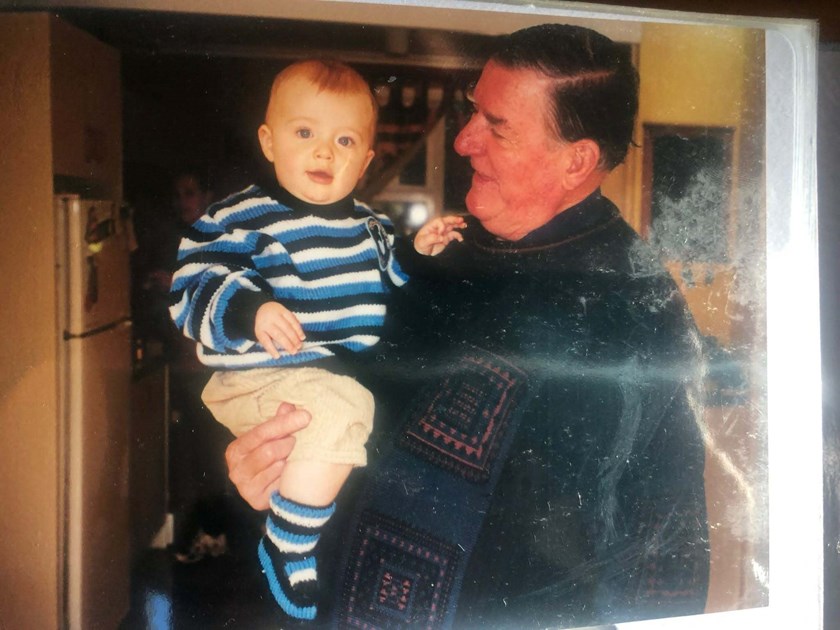 Baby Jesse dressed in a Sharks sweater with his Pop.